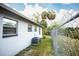 Side yard with chain-link fence and view of trees, vegetation, and an air conditioning unit at 2403 E Osborne Ave, Tampa, FL 33610