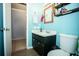 Classic bathroom with a vanity, mirror, and toilet complemented by light blue walls at 2403 E Osborne Ave, Tampa, FL 33610