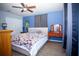Cozy bedroom with a ceiling fan, blue walls, and a large window at 2403 E Osborne Ave, Tampa, FL 33610