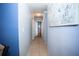 Hallway with tile floors, neutral paint, and access to multiple rooms at 2403 E Osborne Ave, Tampa, FL 33610