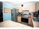 Bright kitchen with stainless steel appliances, wood cabinets, and a breakfast bar at 2403 E Osborne Ave, Tampa, FL 33610