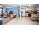 Open-concept living room and kitchen with tile flooring and comfortable seating at 2403 E Osborne Ave, Tampa, FL 33610