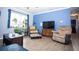 Comfortable living room with wood floors and lots of plants at 2403 E Osborne Ave, Tampa, FL 33610