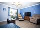 Inviting living room with comfortable seating, wood-look floors, and bright natural light at 2403 E Osborne Ave, Tampa, FL 33610