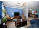 Comfortable living room featuring wood floors, a ceiling fan, and an open floorplan at 2403 E Osborne Ave, Tampa, FL 33610