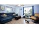 Cozy living room with a blue leather sofa and decorative wall art at 2403 E Osborne Ave, Tampa, FL 33610
