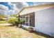 Charming screened porch with brick and plants, perfect for enjoying the outdoors at 2403 E Osborne Ave, Tampa, FL 33610
