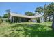 Expansive back yard features a screened in lanai with ample seating room and lush landscaping at 2517 Bucknell Dr, Valrico, FL 33596
