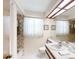 Well-lit bathroom with a combination bathtub and shower, vanity, and bright lighting at 2517 Bucknell Dr, Valrico, FL 33596