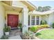 Inviting front entrance with red double doors, tiled porch, manicured landscaping and clear address numbers at 2517 Bucknell Dr, Valrico, FL 33596