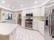 Bright kitchen with stainless steel appliances, tile flooring, and white cabinetry at 2517 Bucknell Dr, Valrico, FL 33596