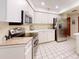Well-lit kitchen features stainless steel appliances, tiled flooring, and ample counter space at 2517 Bucknell Dr, Valrico, FL 33596