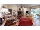 Cozy living room featuring a fireplace, wood floors, and access to the sunroom at 2517 Bucknell Dr, Valrico, FL 33596