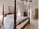 Elegant main bedroom with a four-poster bed, ceiling fan, and ensuite bathroom at 2517 Bucknell Dr, Valrico, FL 33596