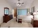 Comfortable main bedroom with a four-poster bed, wood furniture, and light blue curtains at 2517 Bucknell Dr, Valrico, FL 33596