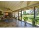 Relaxing screened-in patio with tile floors, ceiling fan, and views of the lush green golf course at 2517 Bucknell Dr, Valrico, FL 33596