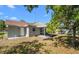Backyard features a shaded patio, well maintained lawn, and home exterior at 2613 E 113Th Ave, Tampa, FL 33612