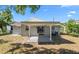 Backyard view of a home with a covered patio and well-maintained lawn at 2613 E 113Th Ave, Tampa, FL 33612