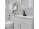 Bathroom view features a modern vanity, framed mirror, and decorative accents at 2613 E 113Th Ave, Tampa, FL 33612