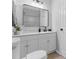 Updated bathroom with framed mirror, modern fixtures, new vanity, and a shower and bath tub at 2613 E 113Th Ave, Tampa, FL 33612