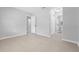 Neutral bedroom with tile flooring and access to the ensuite bathroom and walk-in closet at 2613 E 113Th Ave, Tampa, FL 33612