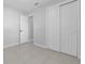 Bedroom features tile flooring, a large closet, neutral paint and an open doorway at 2613 E 113Th Ave, Tampa, FL 33612