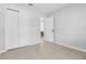 Spare bedroom with double closets, tile flooring, and access to the main living areas at 2613 E 113Th Ave, Tampa, FL 33612
