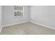 Bright bedroom featuring neutral walls, tile flooring, and a window allowing natural light at 2613 E 113Th Ave, Tampa, FL 33612