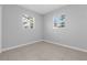 A simply designed bedroom with tile flooring and two large windows for natural light at 2613 E 113Th Ave, Tampa, FL 33612
