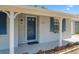 Home showcasing the main entrance with vibrant flower beds and newly painted door and trim at 2613 E 113Th Ave, Tampa, FL 33612