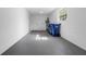 Spacious garage with concrete flooring, a window, and ample storage space at 2613 E 113Th Ave, Tampa, FL 33612