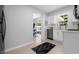 Modern kitchen with backyard access and view, stainless steel appliances, and white cabinets at 2613 E 113Th Ave, Tampa, FL 33612