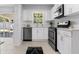 Eat-in kitchen featuring stainless steel appliances, white cabinets, and sliding glass doors to the backyard at 2613 E 113Th Ave, Tampa, FL 33612