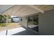 Covered patio with a sliding glass door that lets light in from the outside at 2613 E 113Th Ave, Tampa, FL 33612