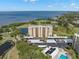 Expansive aerial view of condominium complex near the water, with golf course and pool amenities at 2620 Cove Cay Dr # 704, Clearwater, FL 33760