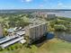 Scenic aerial view of condo community on the water, featuring a pond and lush landscaping at 2620 Cove Cay Dr # 704, Clearwater, FL 33760
