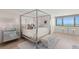 This bedroom features a four poster bed, lots of natural light and beautiful views of the ocean at 2620 Cove Cay Dr # 704, Clearwater, FL 33760