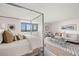 Spacious bedroom featuring a modern bed, seating area, stylish decor, and natural light from large windows at 2620 Cove Cay Dr # 704, Clearwater, FL 33760