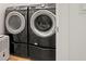 A modern front-load washer and dryer set for convenient laundry, next to dehumidifier at 2620 Cove Cay Dr # 704, Clearwater, FL 33760