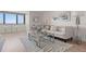 Bright living room featuring modern decor, a plush white sofa, and a chrome and glass coffee table at 2620 Cove Cay Dr # 704, Clearwater, FL 33760