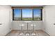Cozy sitting area with views of the golf course featuring sleek, modern bar stools and natural light at 2620 Cove Cay Dr # 704, Clearwater, FL 33760