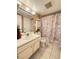 Bathroom with vanity, toilet, decorative shower curtain, and tiled floor at 2625 State Road 590 # 913, Clearwater, FL 33759
