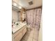 Bathroom featuring vanity, toilet, decorative shower curtain, and tiled floor at 2625 State Road 590 # 913, Clearwater, FL 33759