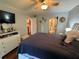 Bedroom with dresser, tv, and ensuite bathroom at 2625 State Road 590 # 913, Clearwater, FL 33759
