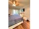 Bedroom featuring sliding doors to balcony, television, and dresser at 2625 State Road 590 # 913, Clearwater, FL 33759