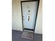 Unit 913's front door with decorative welcome sign and mat enhances the entryway's charm at 2625 State Road 590 # 913, Clearwater, FL 33759