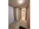 Hallway with tile flooring leads to the bathroom, offering a functional layout in the condo at 2625 State Road 590 # 913, Clearwater, FL 33759