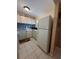 Efficient kitchen design with tile flooring, white appliances, and backsplash at 2625 State Road 590 # 913, Clearwater, FL 33759