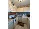 Cozy kitchen featuring white appliances, a stylish backsplash, and upper cabinets for storage at 2625 State Road 590 # 913, Clearwater, FL 33759