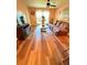 Comfortable living room featuring wood floors, ceiling fan, and a large window at 2625 State Road 590 # 913, Clearwater, FL 33759